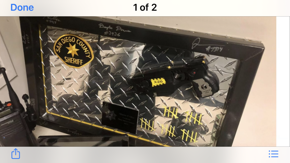 Plaque with a Taser, sheriff's patch and 25 tally marks