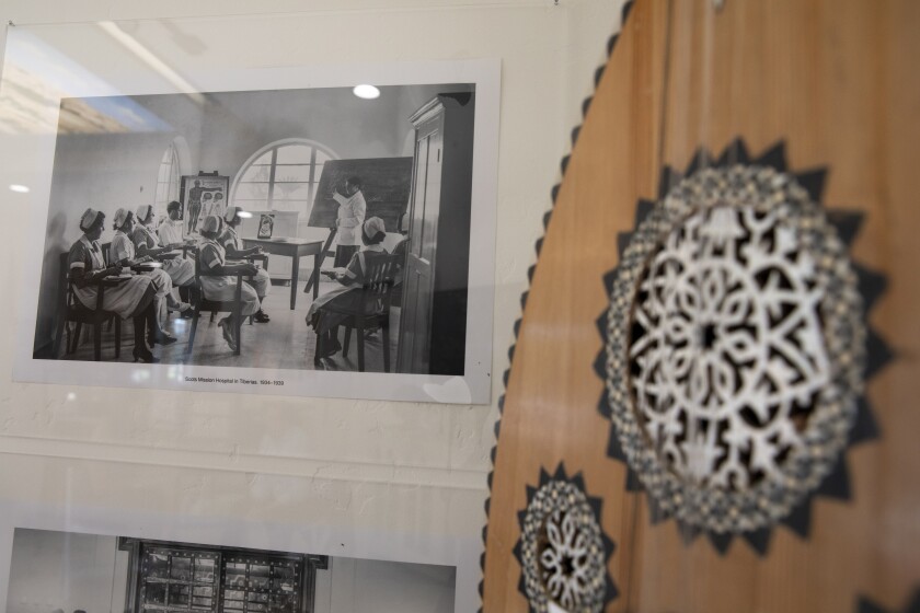 Photos and an instrument called an Oud hangs on the wall of The House of Palestine at Balboa Park