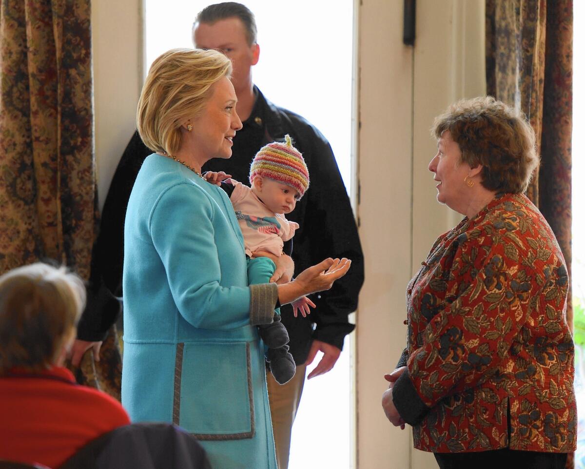 Hillary Rodham Clinton holds 6-month-old Molly Morse while speaking with Marsha Dubois, owner of Kristin's Bistro & Bakery, in Keene, N.H., on April 20. Clinton didn’t embrace such displays during her last run for president.