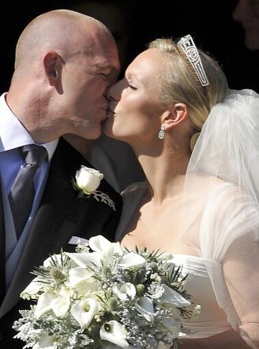 Zara Phillips, granddaughter of Britain's Queen Elizabeth II, kisses her new husband, England rugby star Mike Tindall, after their marriage at Canongate Kirk in Edinburgh, Scotland. Photos: William and Kate wed Photos: Memorable royal pairings over the last century