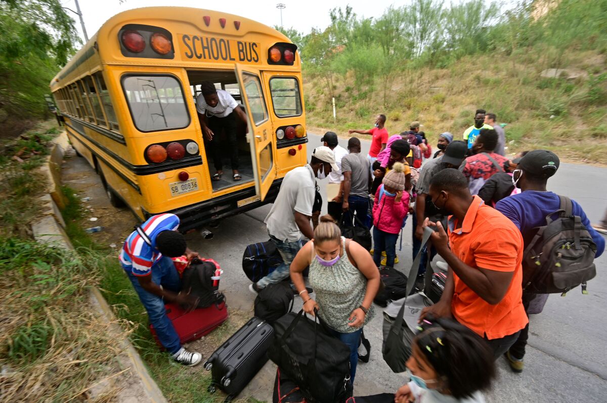 Mostly Haitian migrants prepare to board a bus taking them from a shelter to a U.S. port of entry. 