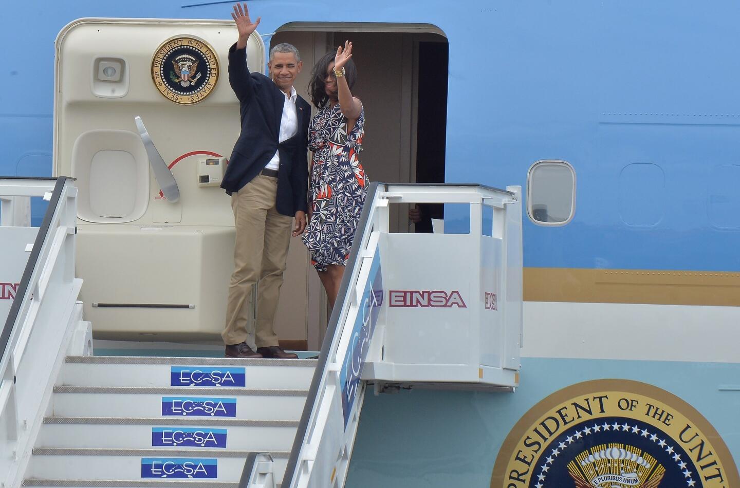President Barack Obama and Michelle Obama wave as they board Air Force One at Jose Marti International Airport in Havana, Cuba, on March 22, 2016, ending the president's historic three-day visit.