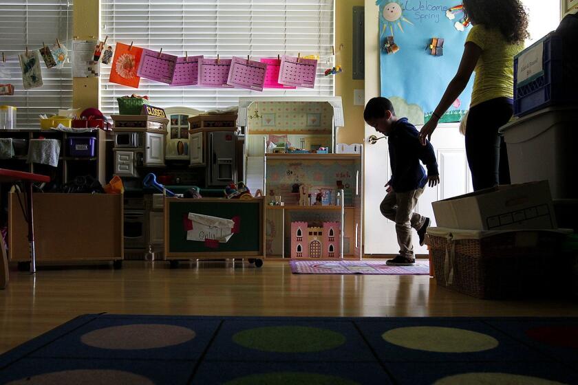 LOS ANGELES-CA-MARCH 27, 2014: A child is lead inside at day care at Alexandria House, which provides hospitality for women and children in need, in Los Angeles on Thursday, March 27, 2014. (Christina House / For The Times)