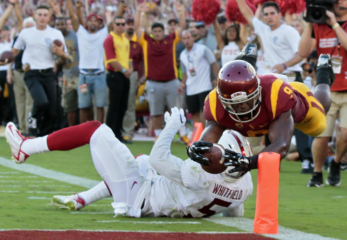 USC receiver Juju Smith-Schuster dives to the pylon over Stanford safety Kodi Whitfield for a touchdown on Sept. 19.