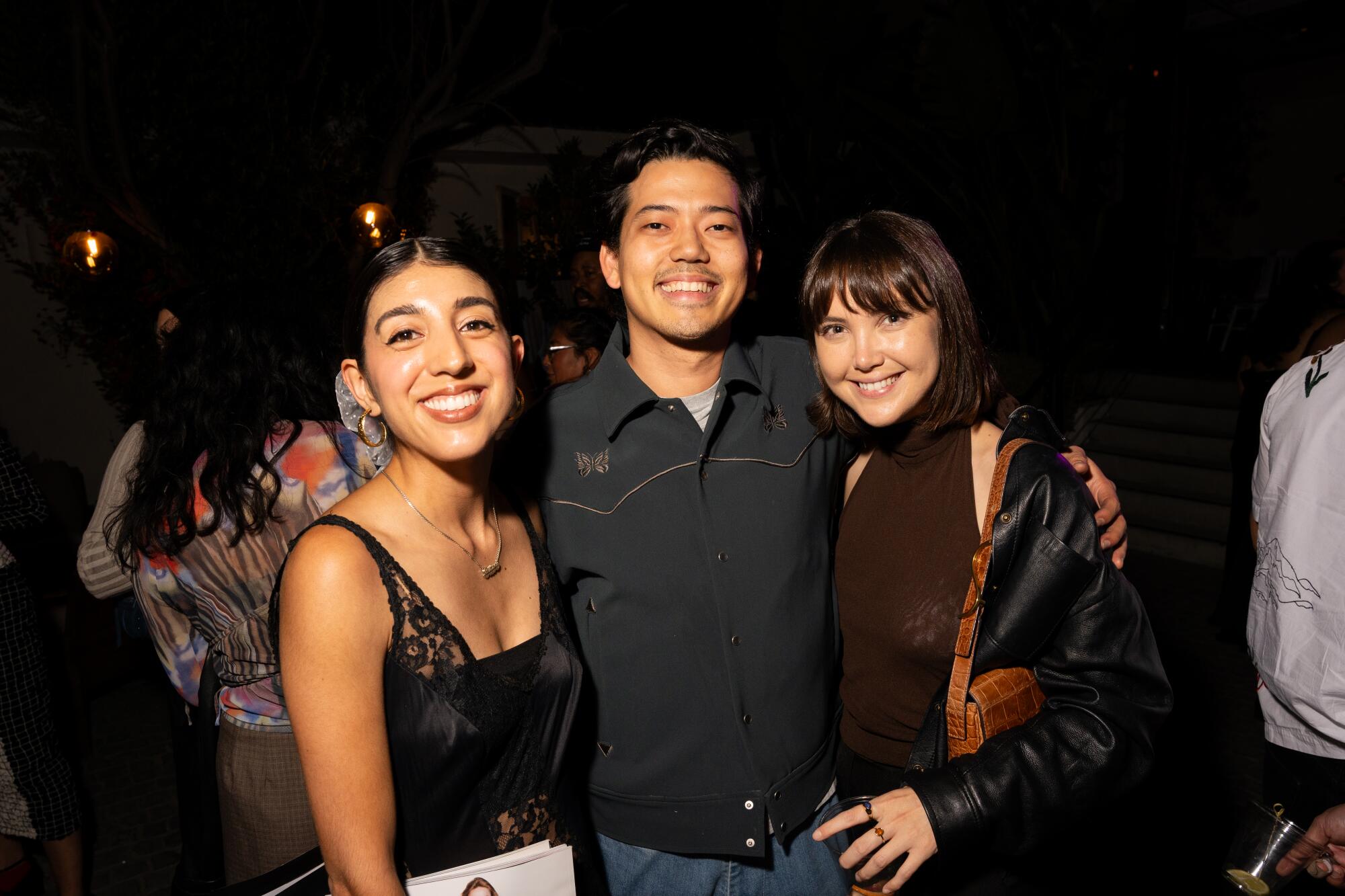 Image contributing photographers Brittany Bravo (left) and Emanuel Hahn (center) with Leah Sarnoff.