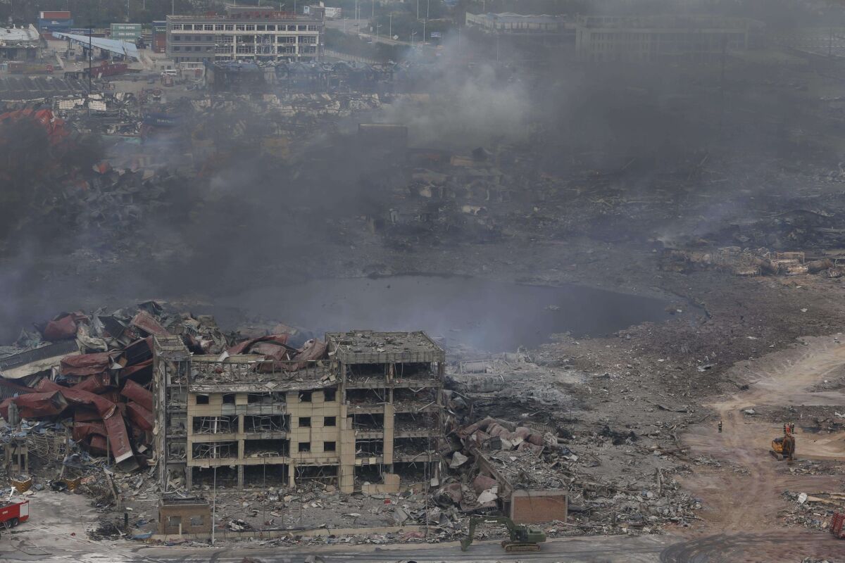 Smoke rises Friday at the site of an explosion in Tianjin. Chinese authorities struggled to extinguish fires and identify dangerous chemicals at a devastated industrial site, two days after giant explosions killed dozens of people.