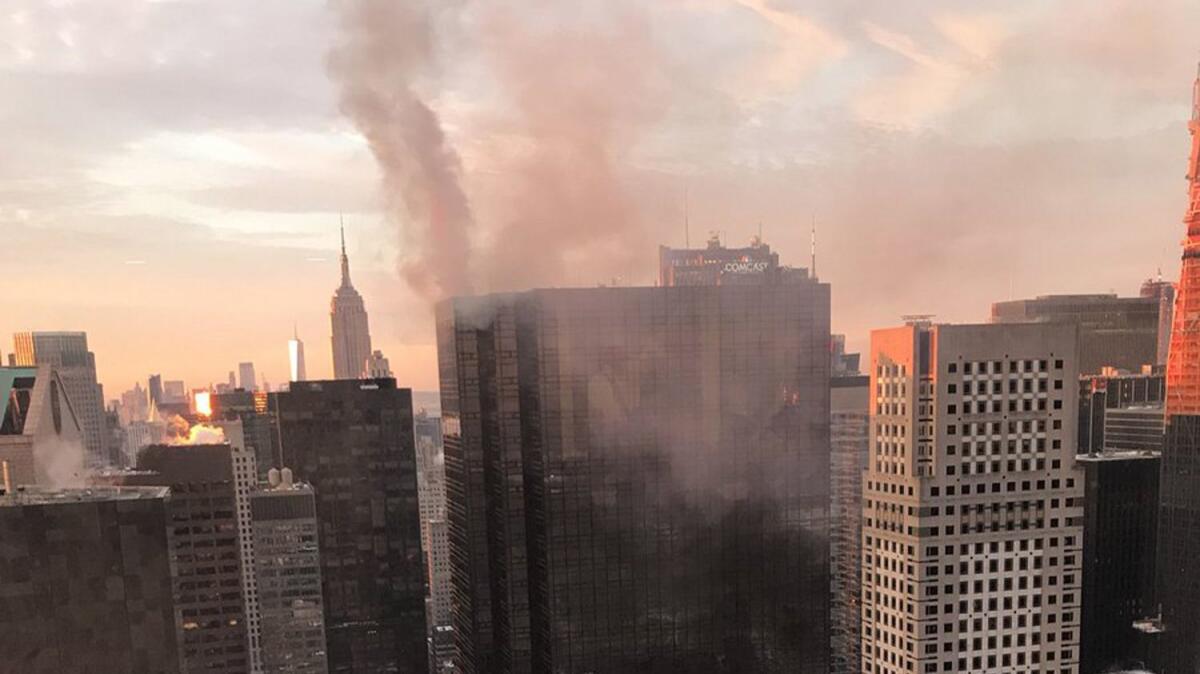 Smoke rises from Trump Tower in New York on Monday. The Fire Department said the fire started around 7 a.m. in the heating and air conditioning system of the building.