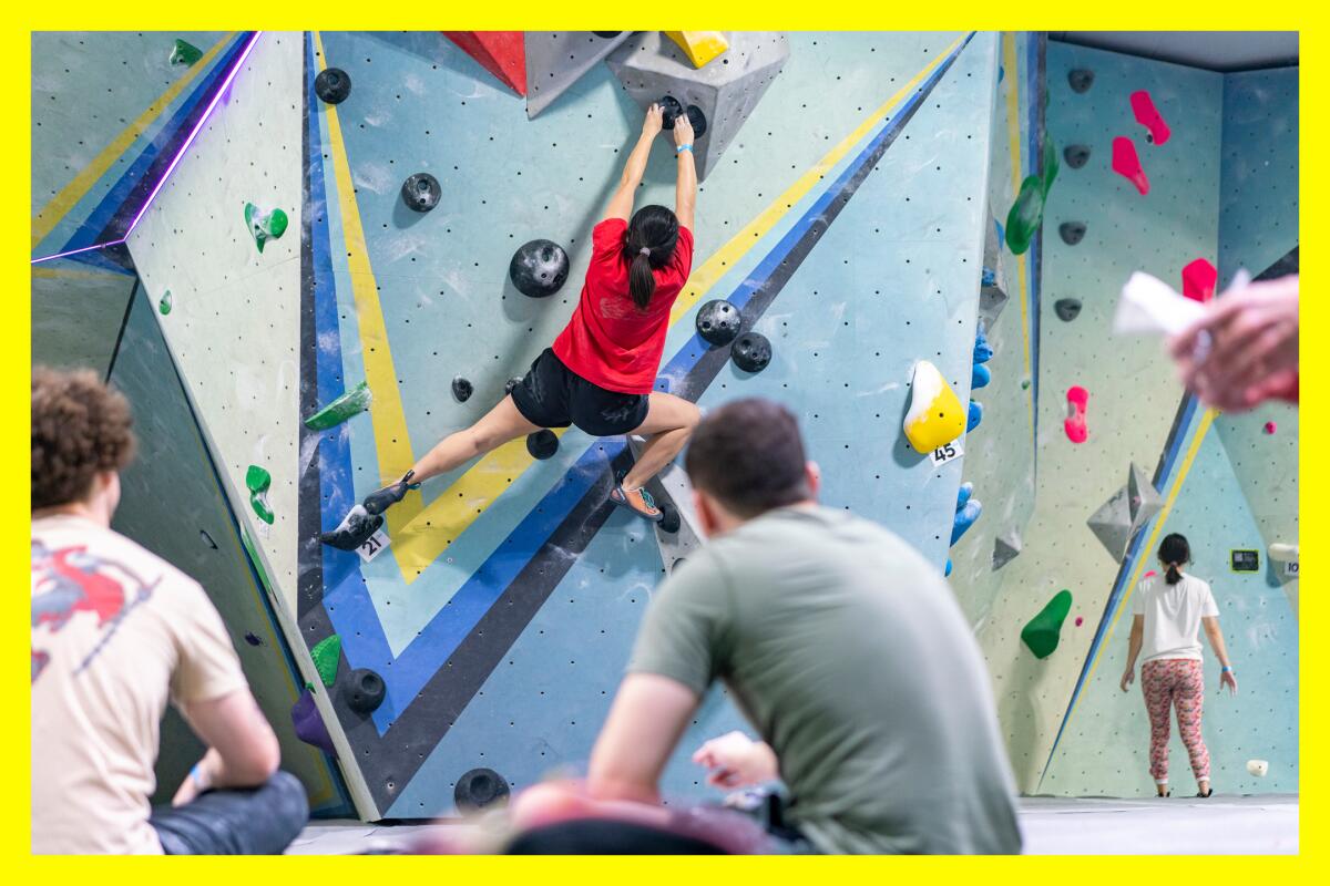 A climber navigates an indoor wall during a competition at Verdigo Boulders in Burbank.