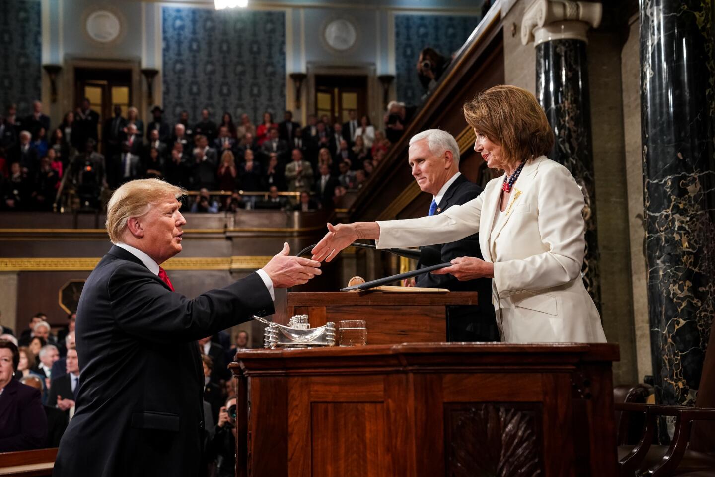 House Speaker Nancy Pelosi welcomes President Trump before his address.