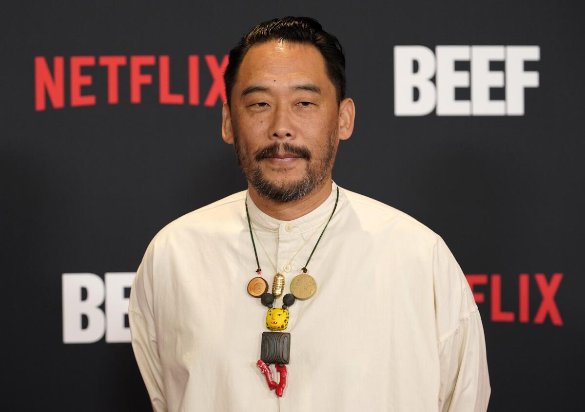 David Choe in a white tunic and abstract necklace at the premiere of Netflix's Beef