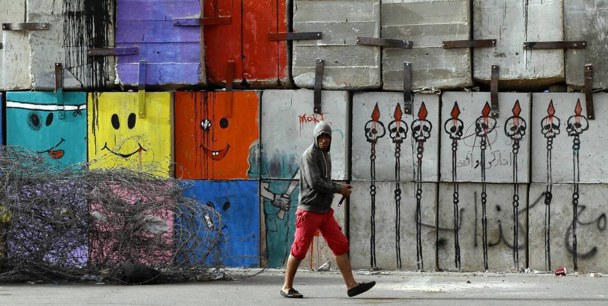 Graffiti is seen on a wall near the presidential palace in Cairo, where tens of thousands of Egyptians have marched in opposition to President Mohamed Morsi.