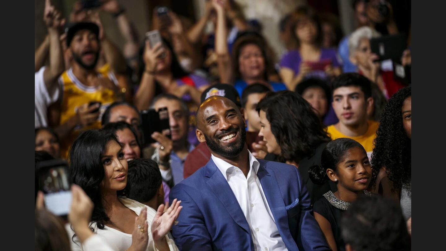 Flanked by his wife, Vanessa Bryant, left, and daughter Gianna Maria Onore Bryant, basketball superstar Kobe Bryant is honored in a ceremony Wednesday — Kobe Bryant Day — in the City Council chambers at L.A. City Hall.