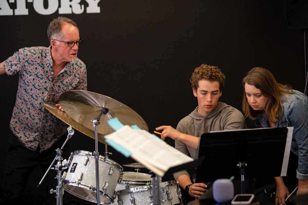 Young Lions Jazz Conservatory's Rob Thorsen and Classics 4 Kids artistic director Dana Zimbric work with Preston Lange.