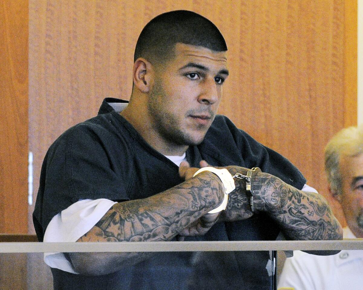 Former Florida Gators and New England Patriots star Aaron Hernandez stands during a bail hearing in Superior Court in Fall River, Mass., in 2013.