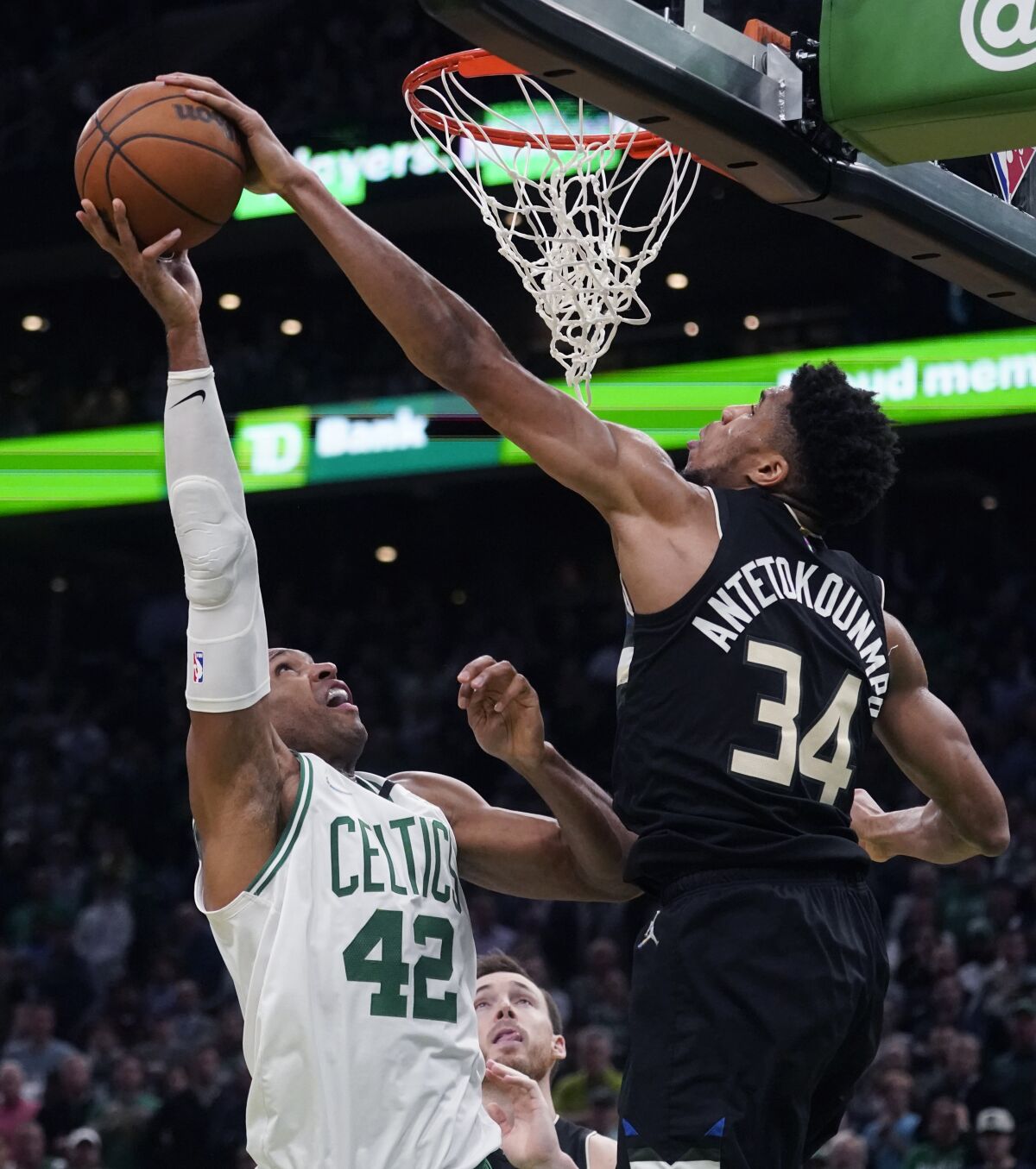 Milwaukee Bucks forward Giannis Antetokounmpo (34) blocks a shot by Boston Celtics center Al Horford (42) during the second half of Game 5 of an Eastern Conference semifinal in the NBA basketball playoffs, Wednesday, May 11, 2022, in Boston. The Bucks won 110-107. (AP Photo/Charles Krupa)