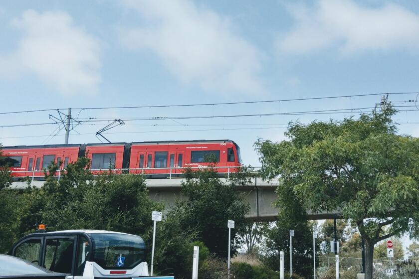 The Blue Line Trolley extension rolls by UC San Diego during a test run Aug. 17.