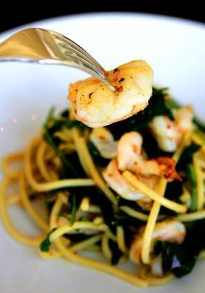 A pasta dish features al dente bucatini with Gulf prawns and slightly bitter wild broccoli.