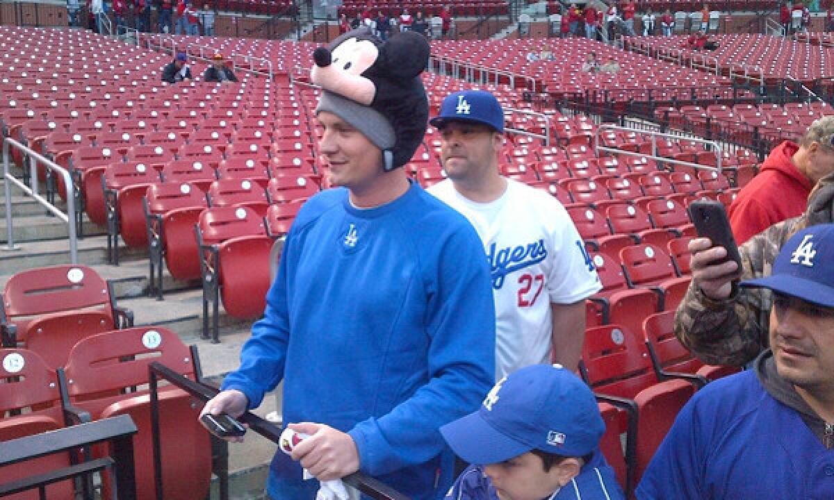 Dodgers fan Gabe Prewitt of Lexington, Ky., shows off his Mickey Mouse hat while watching batting practice before Game 6 of the National League Championship Series between the Dodgers and St. Louis Cardinals at Busch Stadium on Friday.
