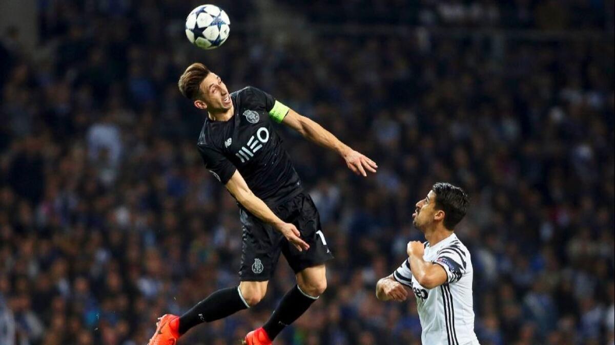 FC Porto's Hector Herrera goes airborne for a header against Juventus' Sami Khedira during a UEFA Champions League game in February.