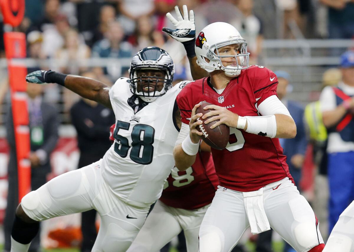 Arizona quarterback Carson Palmer looks to throw under pressure from Philadelphia outside linebacker Trent Cole Oct. 26.