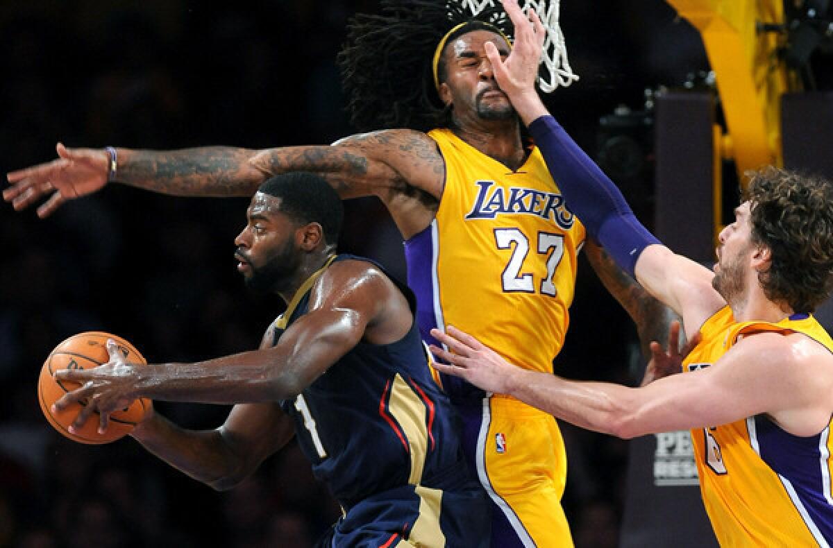 Lakers big men Jordan Hill (27) and Pau Gasol force Pelicans guard Tyreke Evans to pass after driving to the basket during a game earlier this season.