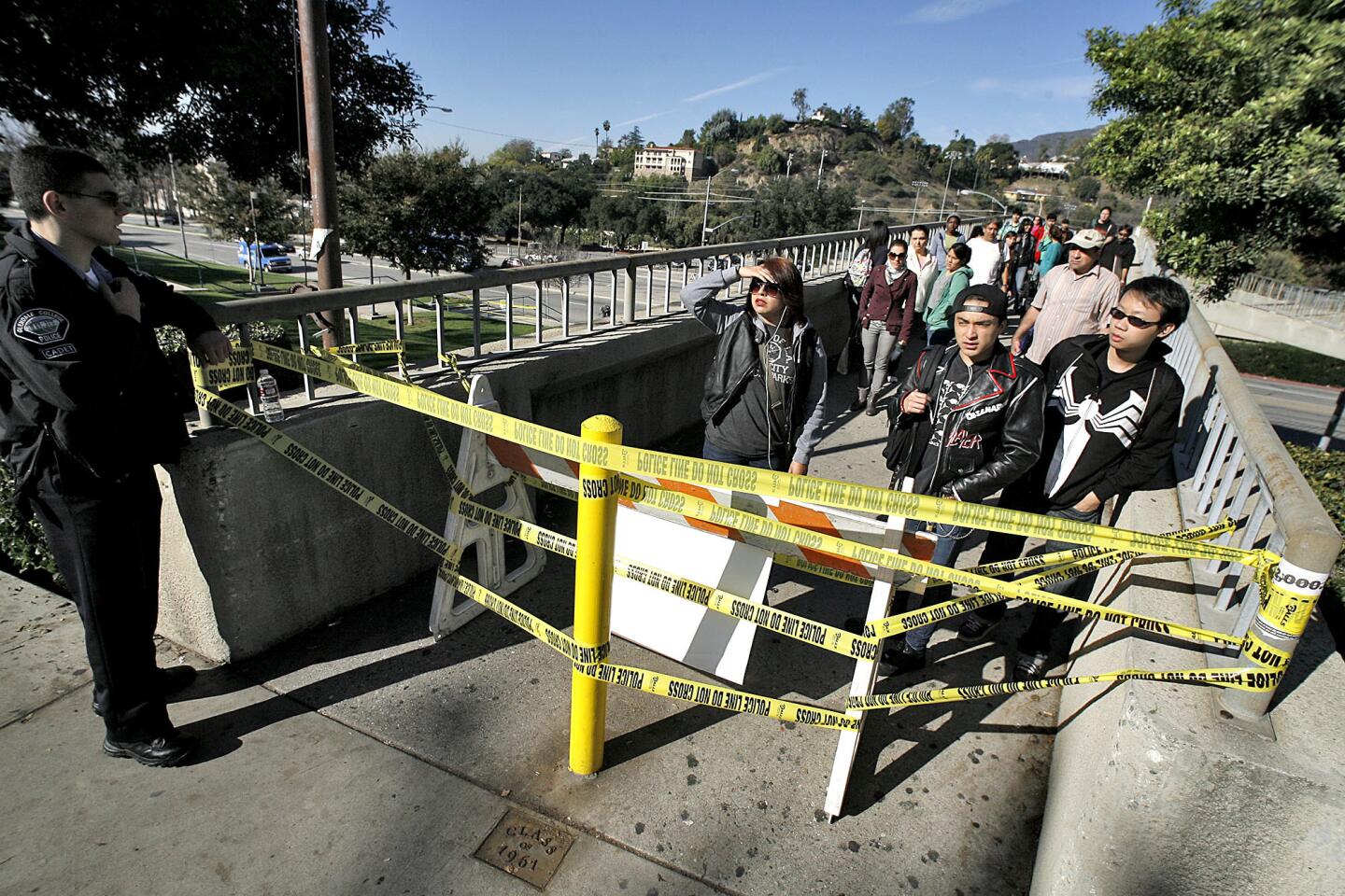 A Glendale College police officer informs a large crowd of arriving students that the campus is closed due to an electrical outage at the main campus in Glendale on Wednesday, December 5, 2012. This is the second time in two weeks that the campus has been closed due to a power failure.