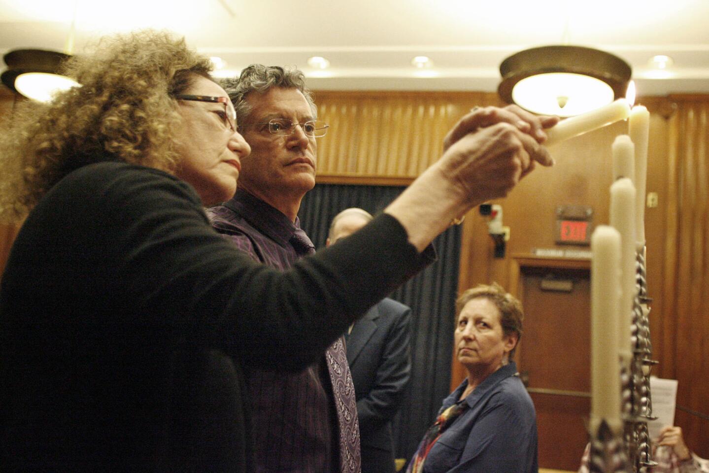 Nina Guttman and David Drexter light a candle in remembrance of Drexter's mother, Rena, during the Holocaust and Armenian genocide memorial candle lighting, which took place at Burbank City Hall on Tuesday, April 23, 2013.