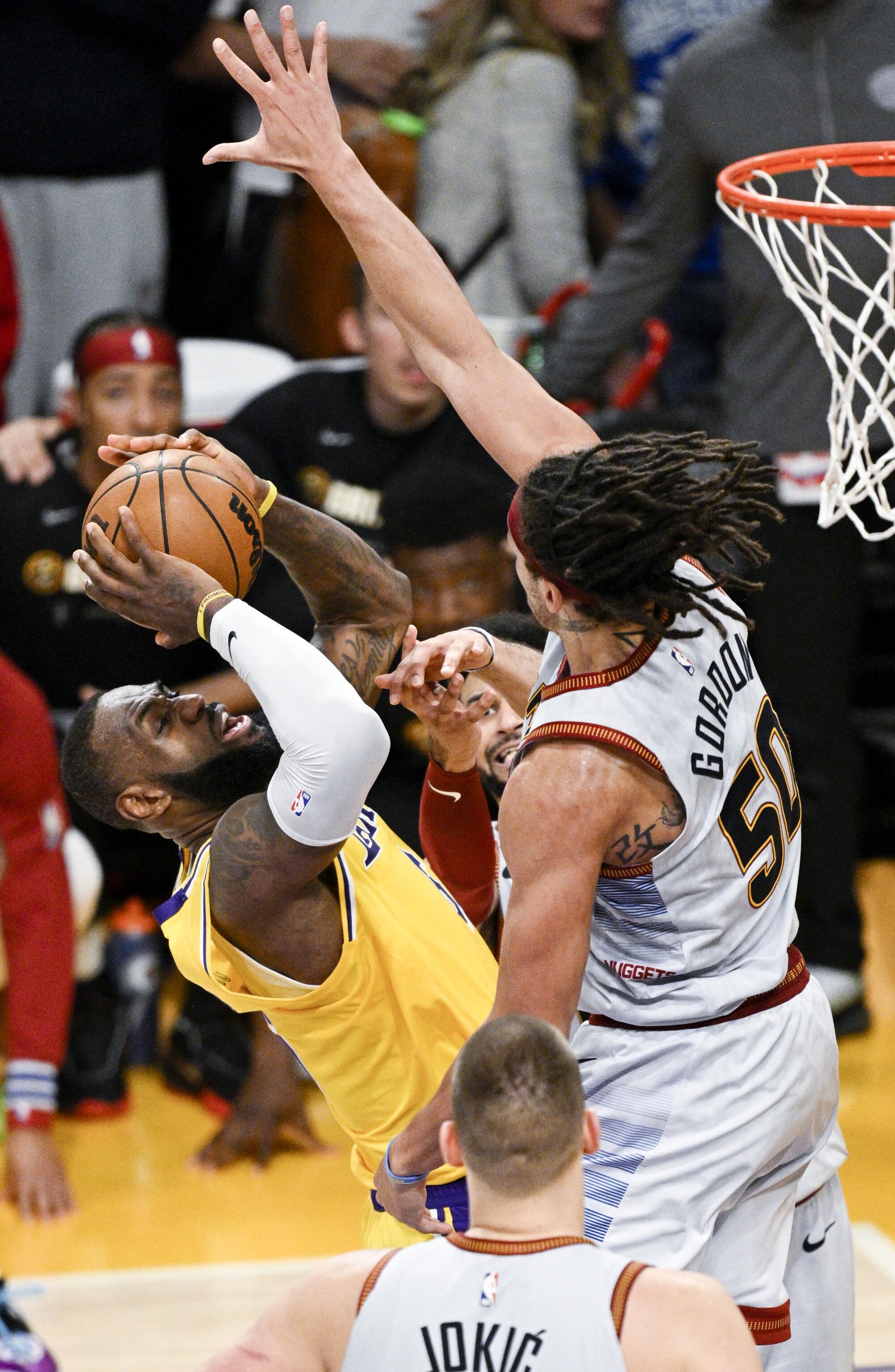 Denver forward Aaron Gordon blocks a shot attempt by Lakers forward LeBron James.