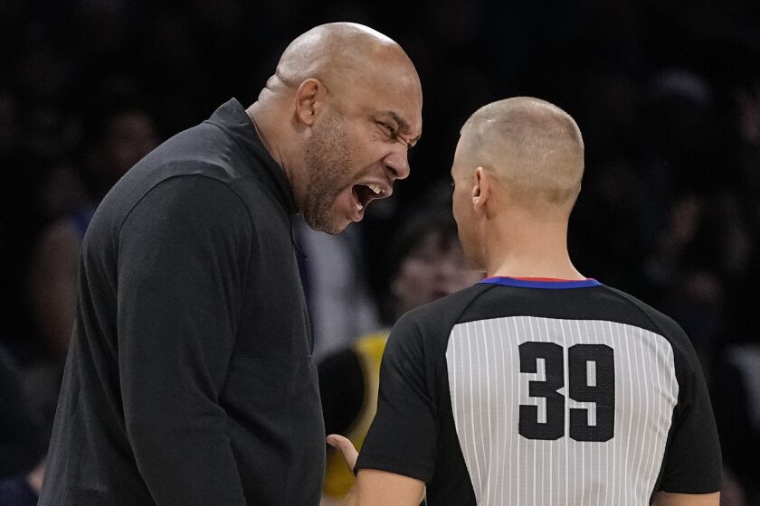 Los Angeles Lakers head coach Darvin Ham, left, yells at referee Tyler Ford after they received a technical foul 