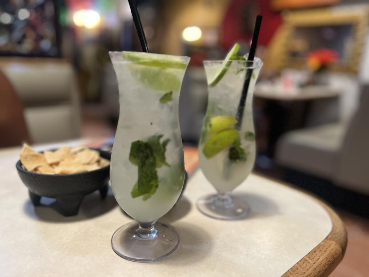 Two mojitos and a bowl of tortilla chips from Fiesta Martin Mexican Grill. 