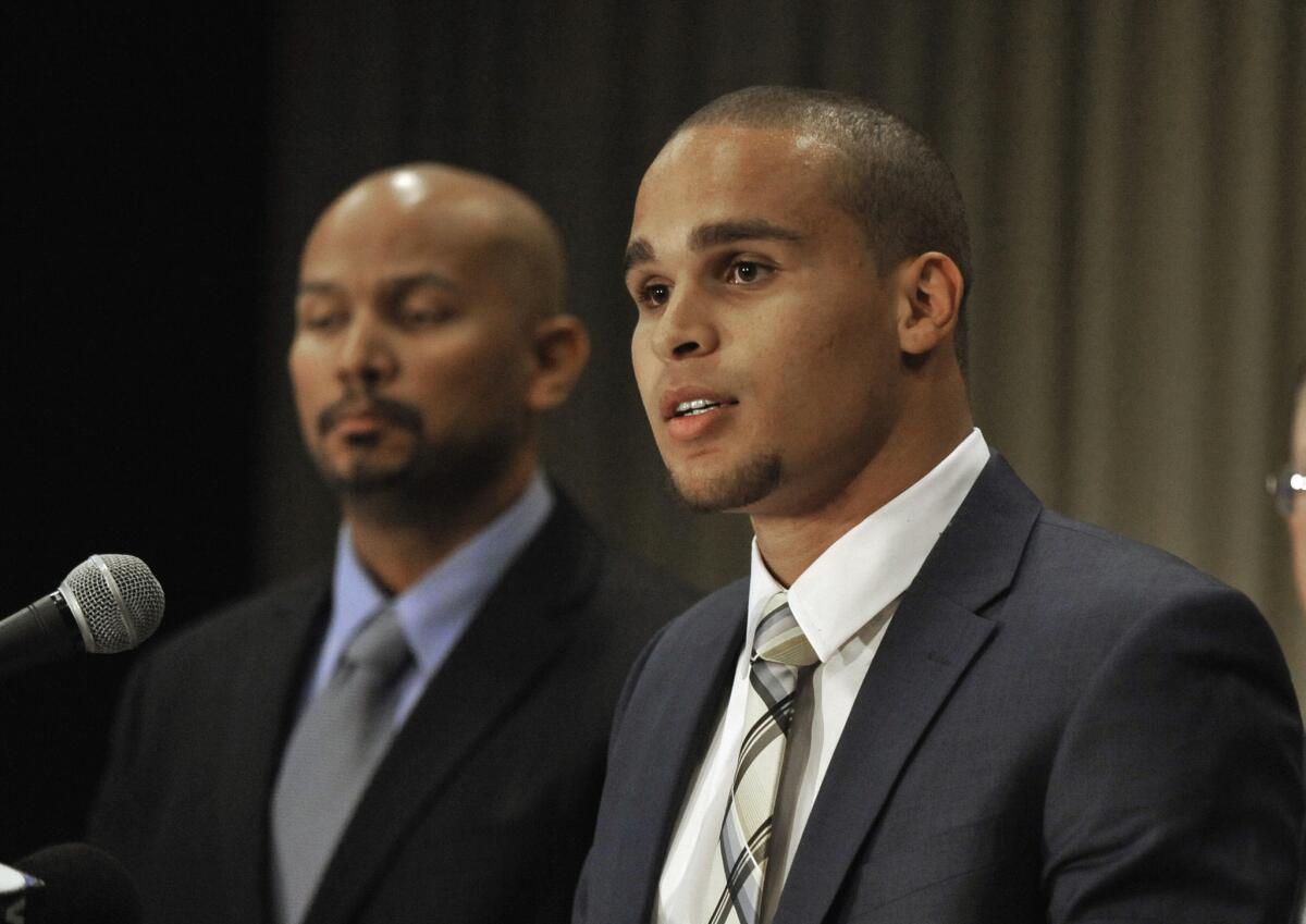 Northwestern quarterback Kain Colter, right, speaks while College Athletes Players Association President Ramogi Huma listens during a news conference in Chicago. In a landmark ruling Wednesday, a federal agency gave football players at Northwestern University the green light to unionize.