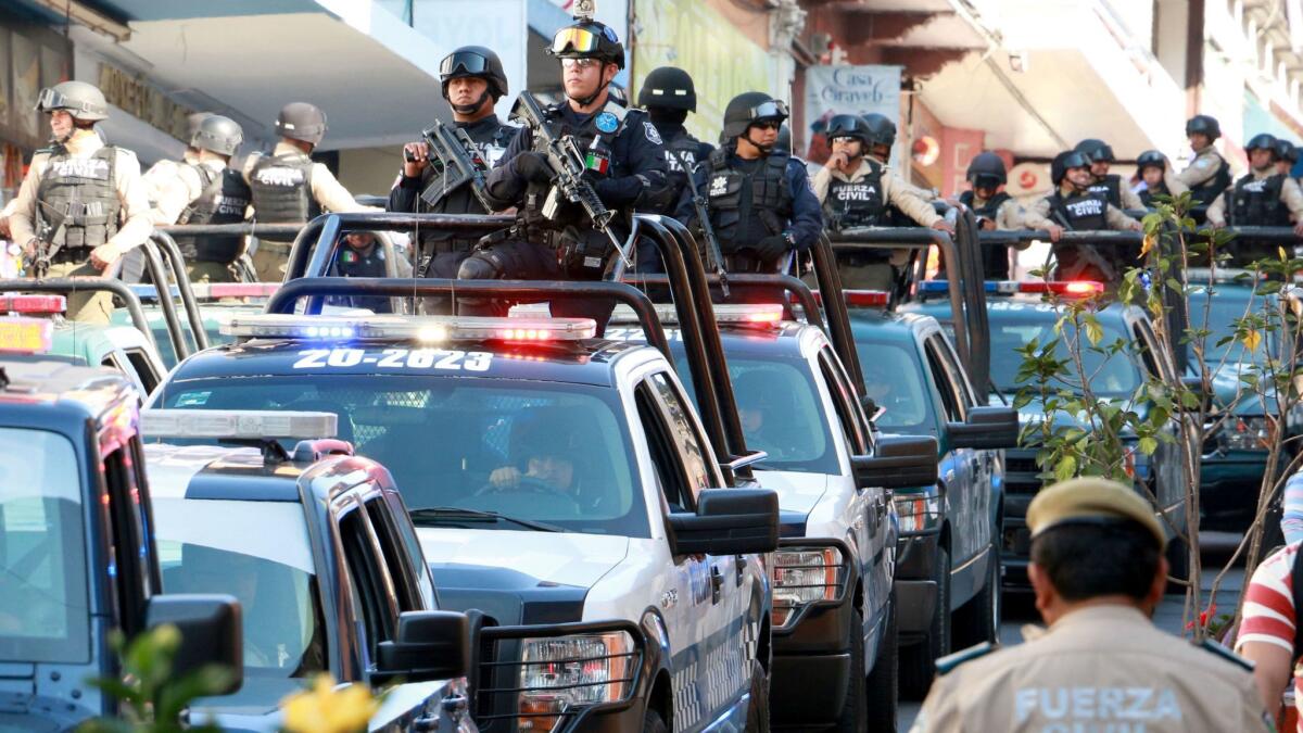 A convoy carrying gendarmerie, civil and state police personnel arrives March 1 in Jalapa, Veracruz state, to strengthen security.