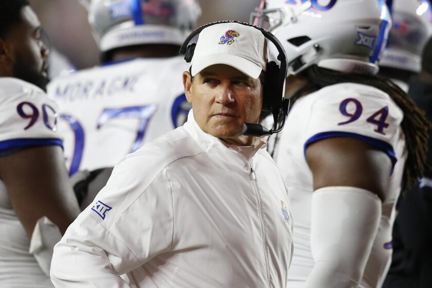 FILE - In this Sept. 13, 2019, file photo, Kansas coach Les Miles stands with his team during a timeout in the second half of an NCAA college football game against Boston College in Boston. Kansas plays Baylor this week in Baylor coach Dave Aranda's debut. (AP Photo/Michael Dwyer, File)