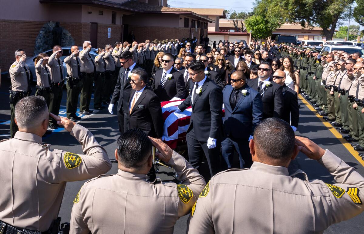 L.A. County Sheriff's Deputy Freddy Flores's casket is carried into St. Didicus for his funeral mass on May 9 in Sylmar.