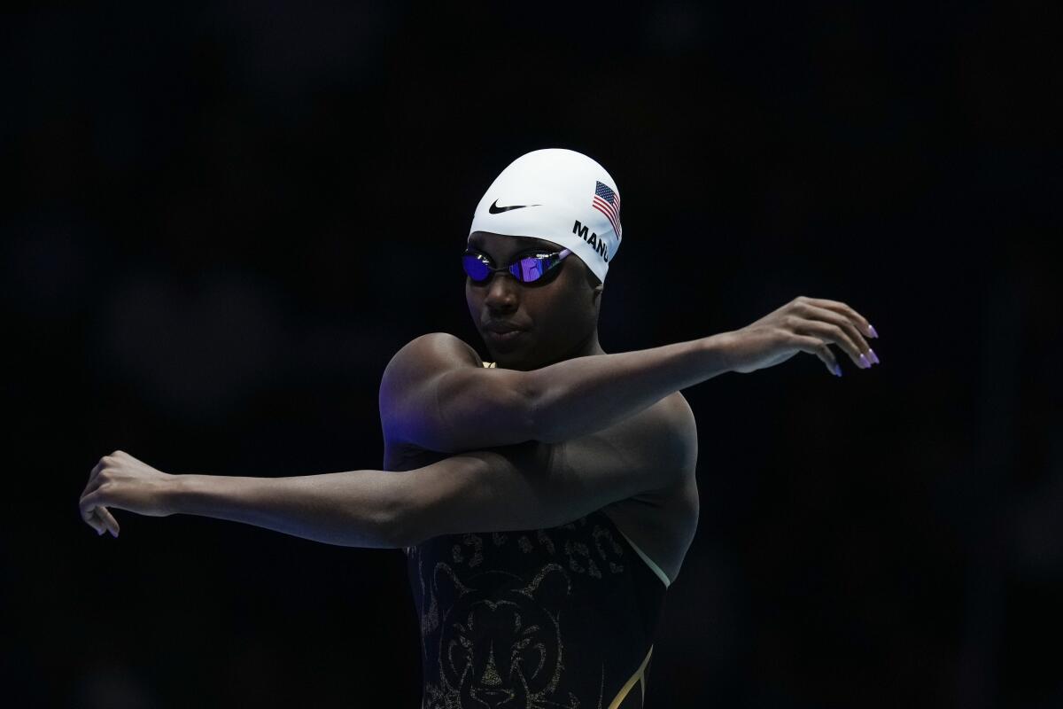 Simone Manuel stretches before a Women's 100 freestyle semifinals heat.
