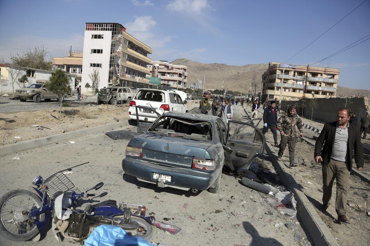 Afghan security personnel gather at the site of a car bomb attack in Kabul on Nov. 13, 2019.