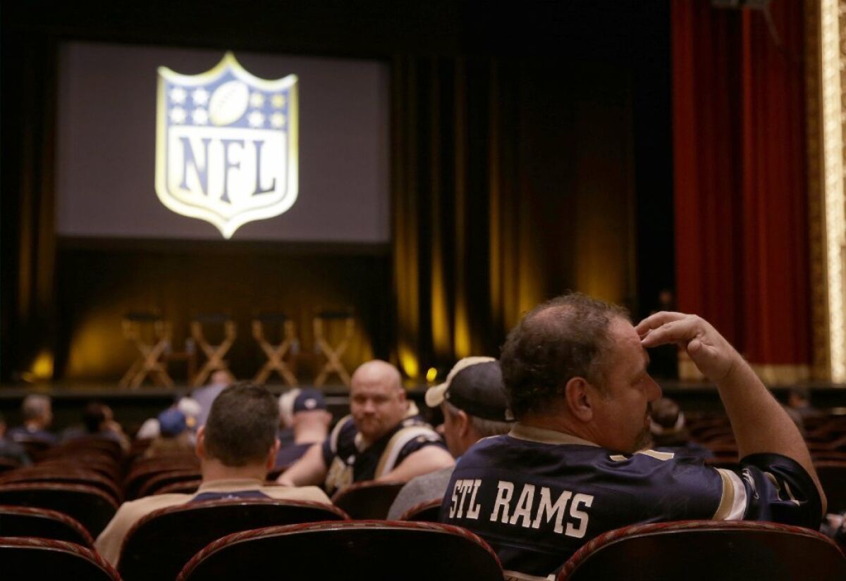 St. Louis Rams fan Ted Surgant talks to other fans as they wait for the start of a town hall meeting hosted by the NFL to gather comments from football fans on the possible relocation of the St. Louis Rams to Los Angeles.