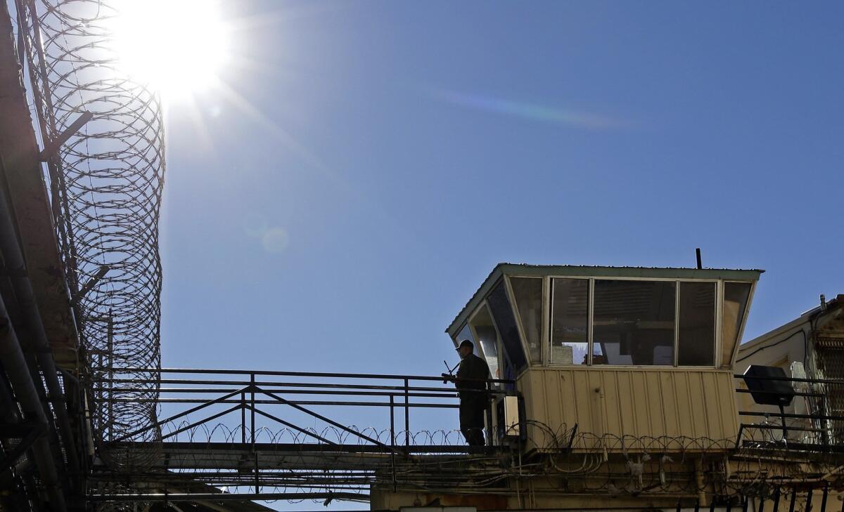 An armed guard stands watch on a gun ramp at San Quentin State Prison on Dec. 29, 2015.