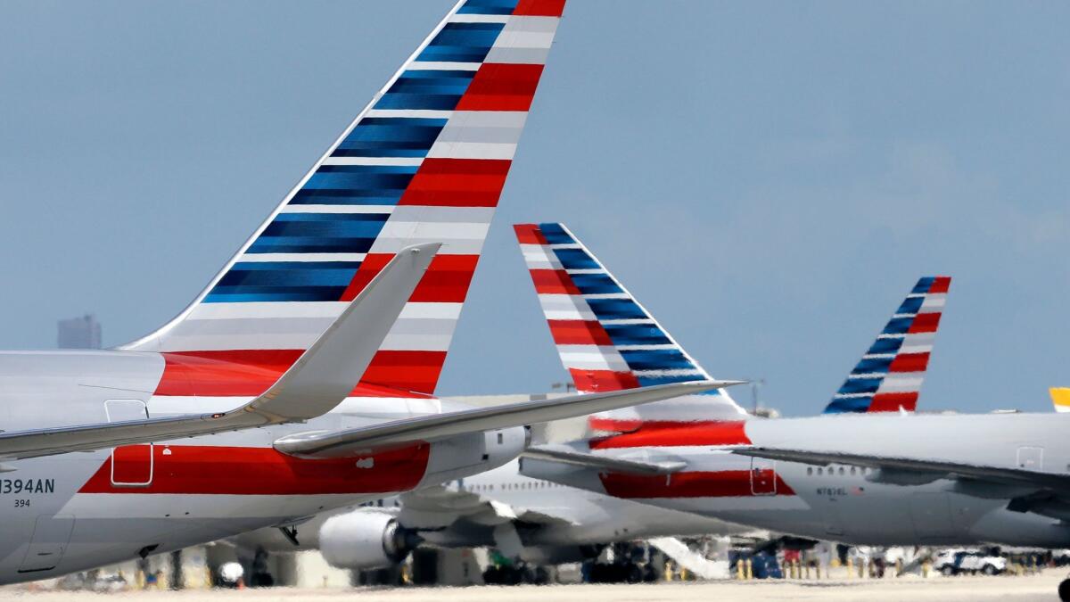 American Airlines jets taxi at Miami International Airport. A merger with US Airways made American Airlines the world's largest carrier. A judge has refused to dismiss an antitrust lawsuit against the nation's biggest airlines.