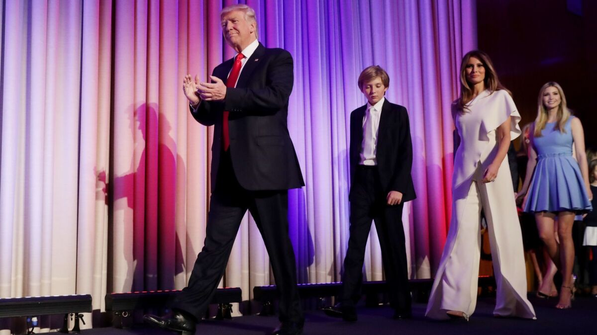 Donald Trump walks on stage with his son Barron Trump, wife Melania Trump and Ivanka Trump.