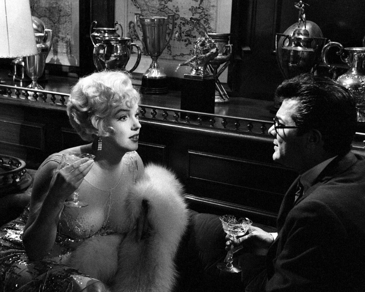 Marilyn Monroe and Tony Curtis attempt to seduce each other in a scene from the comedy "Some Like It Hot" in 1959. 