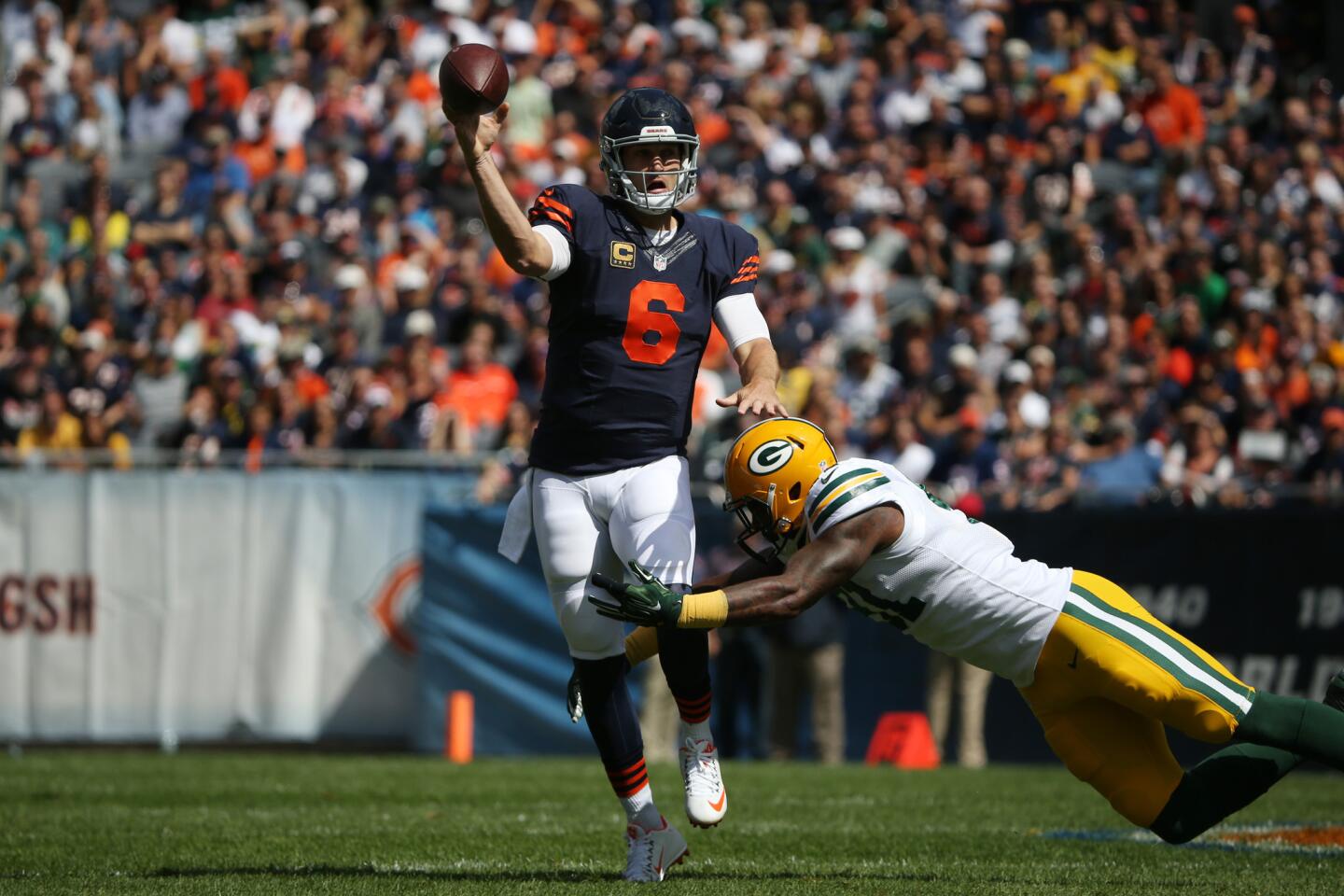 Jay Cutler tries to get off a pass before being tackled by Green Bay Packers linebacker Jay Elliott during the first quarter of their game.