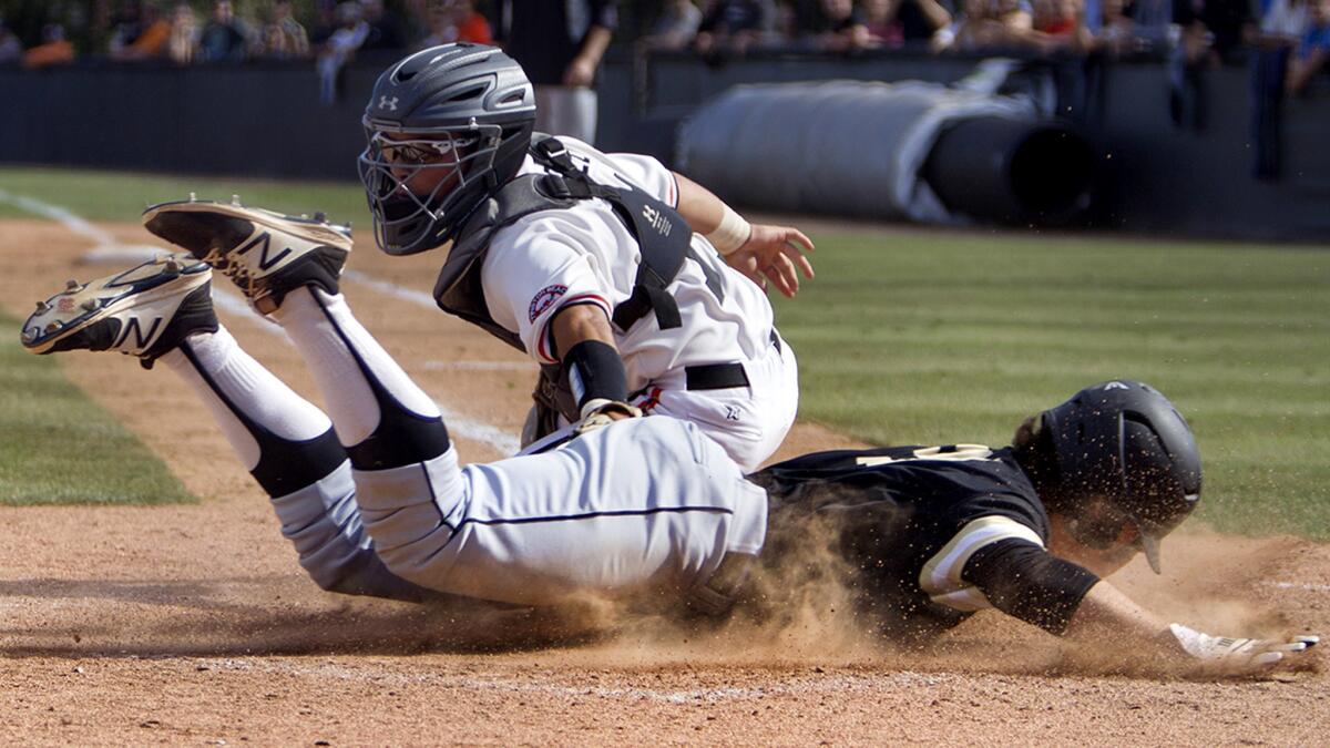 Huntington Beach catcher Nick Lopez is unable to make the tag as El Dorado's Augie Mattei scores a run during the sixth inning Friday.