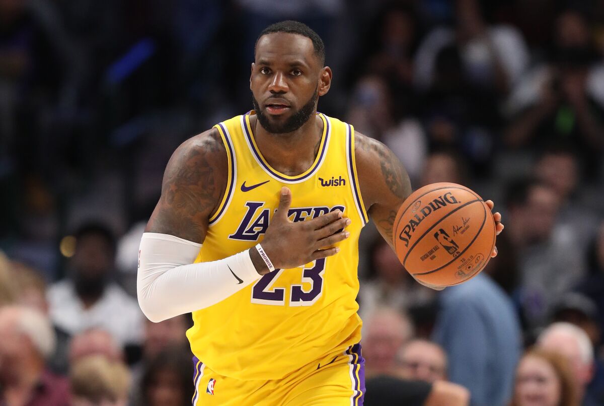 LeBron James wears the Lakers' gold jersey during a road win over the Dallas Mavericks.