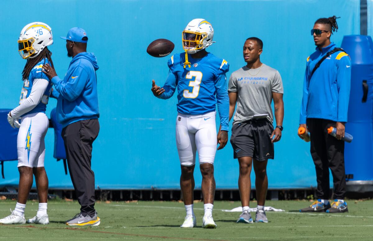 Chargers safety Derwin James Jr. (3) flips a football while watching practice.