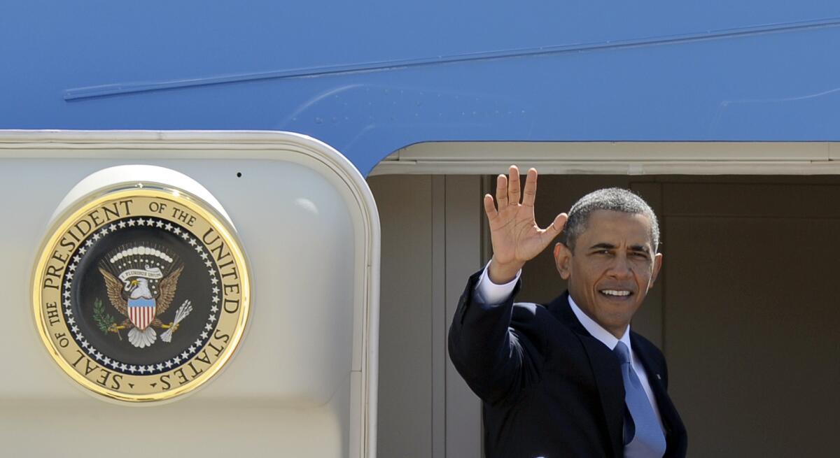 President Obama waves from the steps of Air Force One at Andrews Air Force Base, Md., as he boards a flight for Mexico.