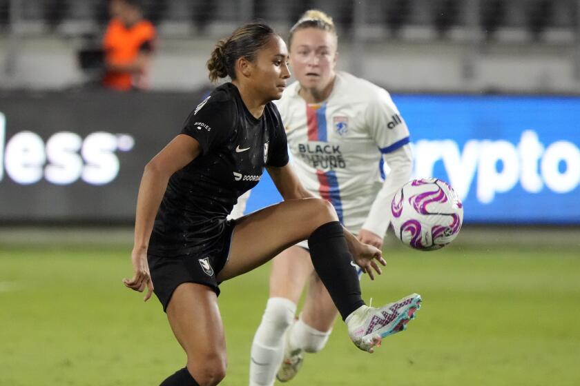 Angel City's Alyssa Thompson controls the ball against OL Reign.