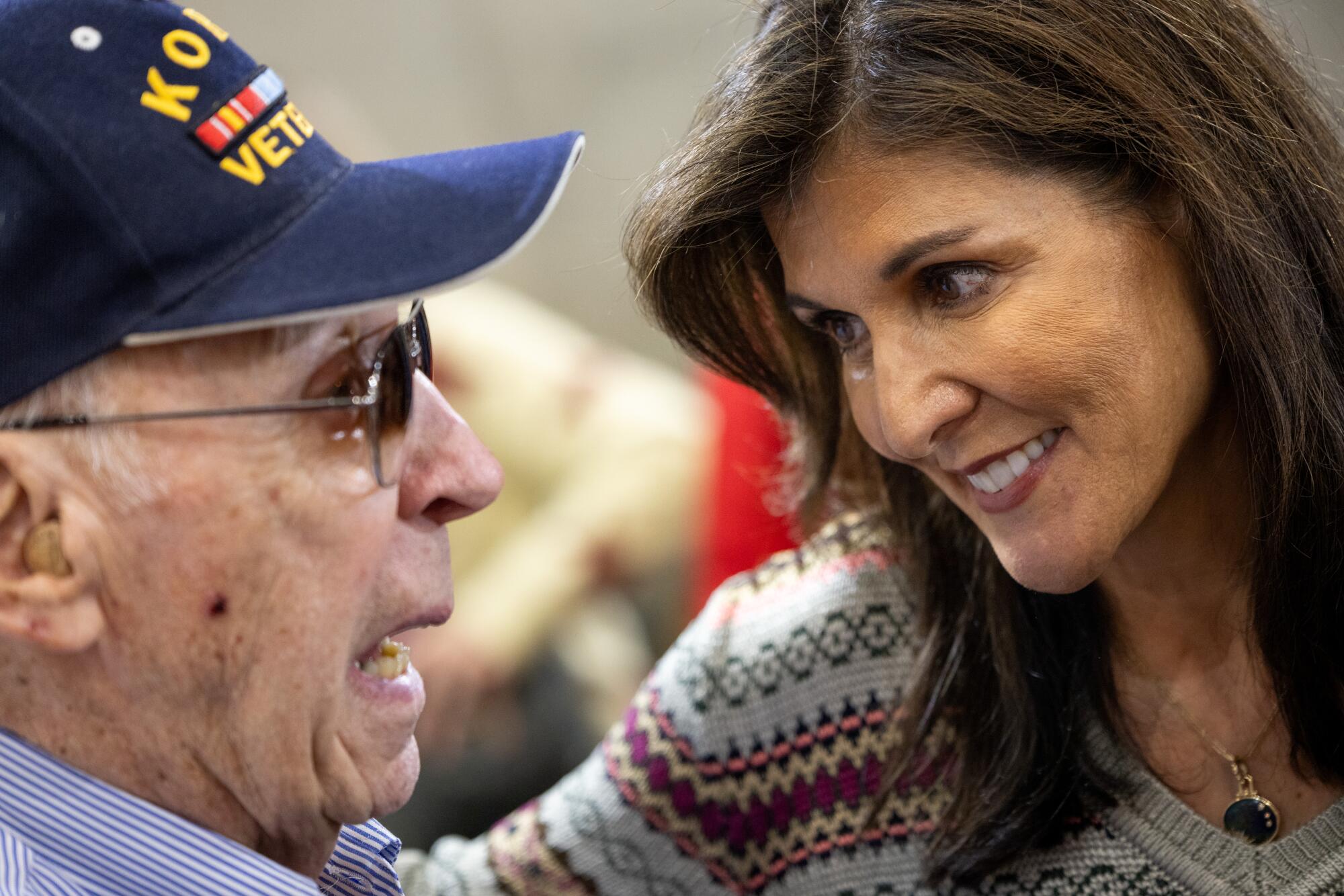 Nikki Haley talks to a veteran in a cap