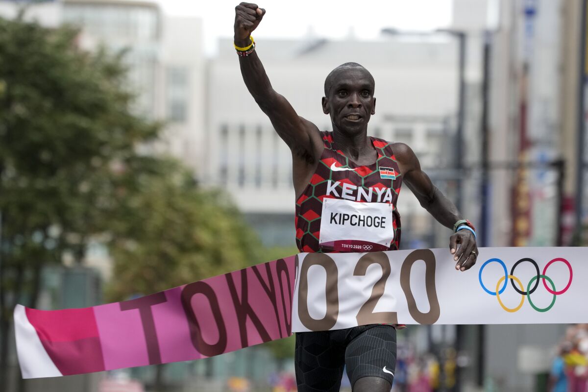 Eliud Kipchoge of Kenya celebrates as he wins gold in the men's marathon.