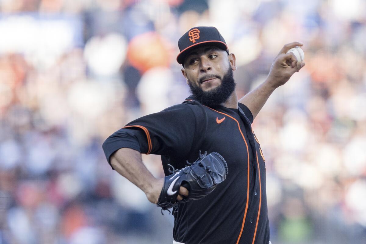 San Francisco Giants relief pitcher Jarlin Garcia delivers against the Dodgers in the first inning Saturday.